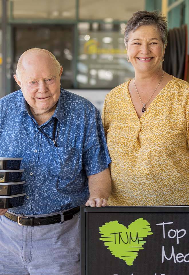 owner and customer with food